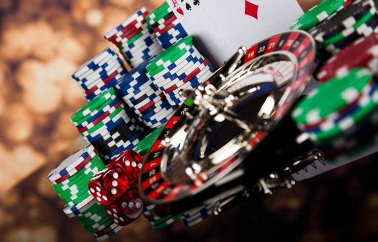 Small Roulette Wheel Surrounded by Stacks of Chips